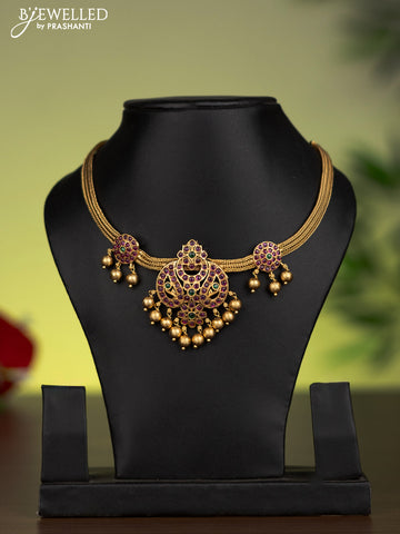 Antique attigai necklace with kemp stones and golden beads hanging without earrings