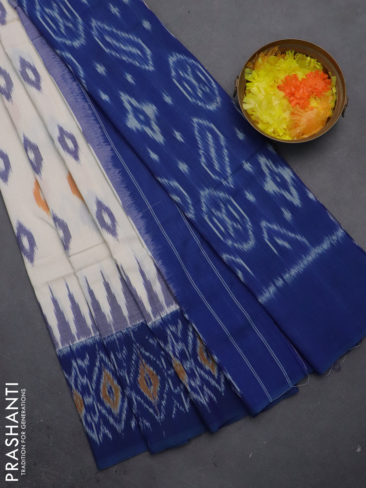 Ikat cotton saree cream and blue with allover ikat butta weaves and temple design ikat style border