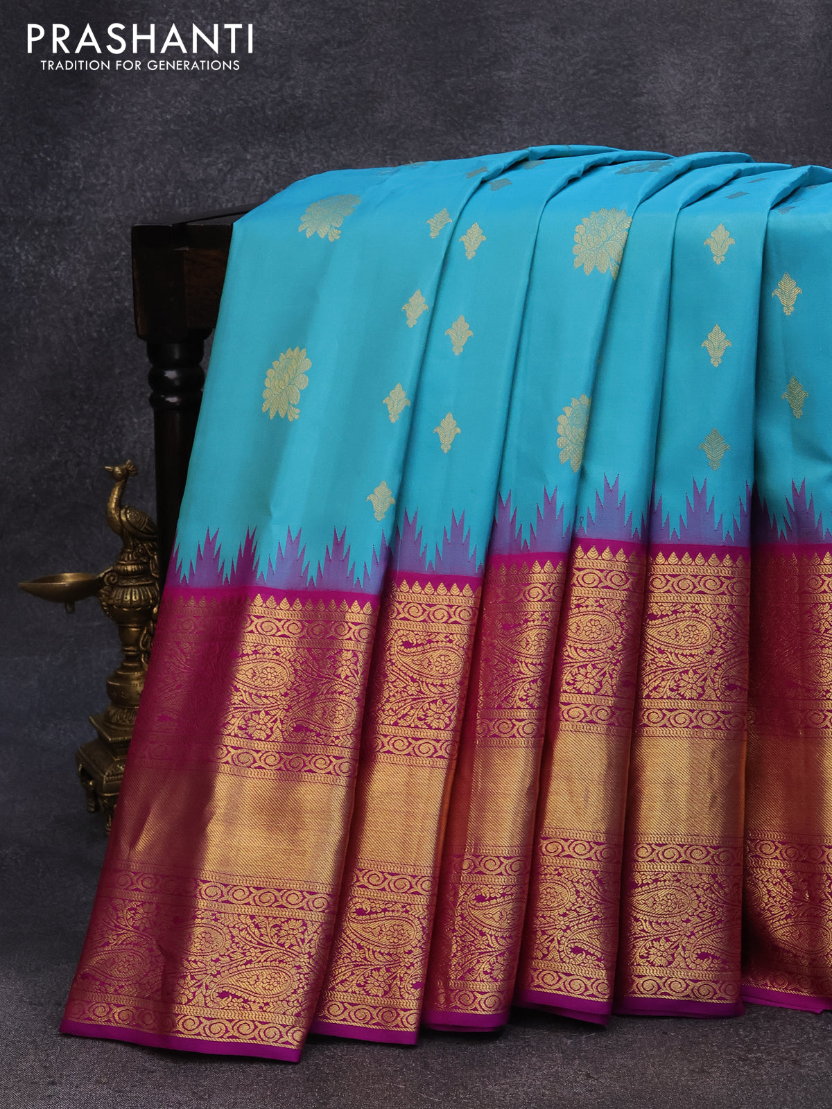 Pure gadwal silk saree light blue and purple with allover zari woven buttas and temple design long zari woven border